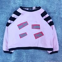 Full front view of sweater showing design, color, and overall condition