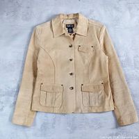 Front view of brown leather jacket showing overall style, pockets, and buttons