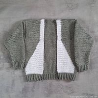 Front view of grey and white baby cardigan laid flat