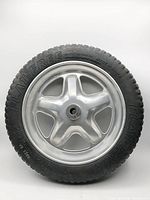 Front view of 15-inch flat-free wheelbarrow tire on silver rim