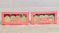 Front view of both boxed kits showing wood hearts, paint pots and brush inside