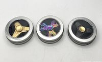 All three fidget spinners in tins