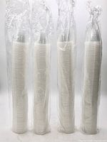 Four sealed sleeves of nested clear cups