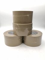 Four rolls of tan flatback packing tape stacked