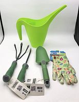 All five garden items: watering can, three hand tools, gloves