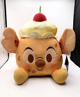 Front view of Stitch Pineapple Upside-Down Cake plush showing facial features and cherry topper