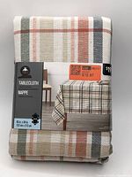 Front of packaged Hometrends tablecloth showing plaid pattern, brand, dimensions 60" x 84"