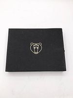 Closed black box with gold bear logo