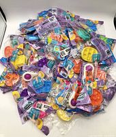 Pile of sealed ORB Sensory Bubble Popper packages showing quantity and colour variety