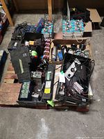 Pallet with multiple battery packs, loose cell arrays, housings and wiring visible
