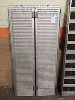 Pair of aluminum ramps folded together, full view