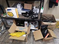 Full shelving unit with phones, headsets, sanitizer bottles, boxes and cables
