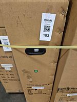 Closed cardboard shipping box labelled Model Milan Ebike M