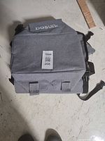 Front view of gray DOSUN bike rear bag with tag attached