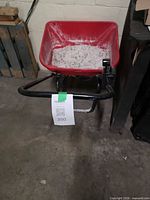 Front view showing red hopper with residue and handle