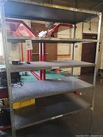Full front view of galvanized steel shelving unit with five shelves