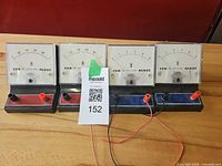 Front view showing four Globe meters, two ammeters (0–0.8 A) and two voltmeters (0–5 V) with test leads