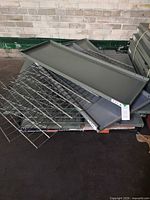 Stacked solid steel shelving panels and wire grids on pallet