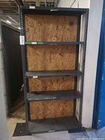 front view of full shelving unit showing five shelves and wood back
