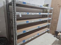Front view of full shelving unit showing five tiers and overall construction