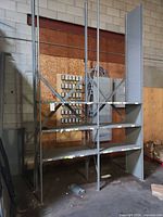 Full view of steel shelving unit with four shelves and three uprights