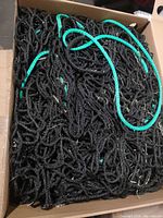 Net coiled in box showing black rope and green edge