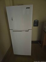 Front view of Magic Chef white top-freezer refrigerator