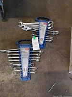 Two blue Mastercraft plastic racks holding full set of metric combination wrenches
