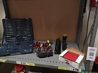 Shelf with open Mastercraft tap & die set, screwdrivers, multimeter, staplers, box of cable ties