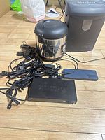 Group view of rice cooker, shredder, D-Link switch and cables on floor