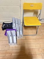 Lot overview showing chair, magazine holders, trays