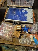 Lot overview showing aluminum display frame, ornaments, hardware