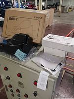 Scanner resting on cabinet with box, manual visible