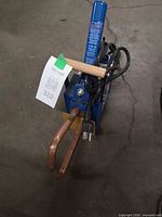 Front angled view showing copper electrode arms, power cord and plug