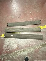 All three black rubber cable protector strips laid out