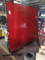 Full view of red welding screen on casters