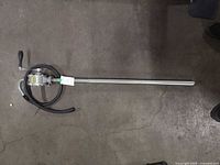 Full view of rotary pump with attached suction tube and hose