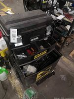 Full view of Stanley rolling tool chest open with visible compartments and mixed contents