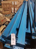Stack of blue steel pallet rack beams on pallet