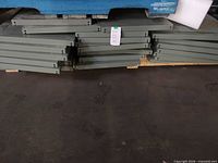 Stacked steel shelving panels on pallet, showing quantity and color