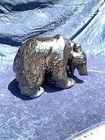 Left side view of glossy ceramic bear figurine