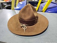Front angled view showing crown shape, brim and leather band with lace
