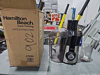 Juicer next to original box, juice container visible