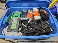 Open blue tote showing packaged Pawz boots, Bright Steps pack, loose booties, leashes, harnesses, mesh pouch, grey garment