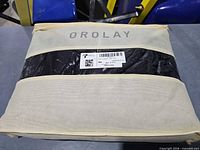 Beige mesh Orolay storage bag containing vest