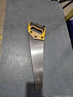 Full view of Stanley FatMax hand saw on tabletop