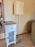 Cabinet and floor lamp side by side