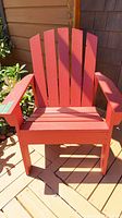 Front view of red painted wooden deck chair