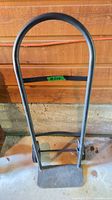 Front view of metal hand truck showing full frame and nose plate