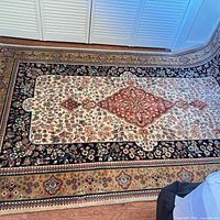 Full view of the rug showing pattern, borders and colors